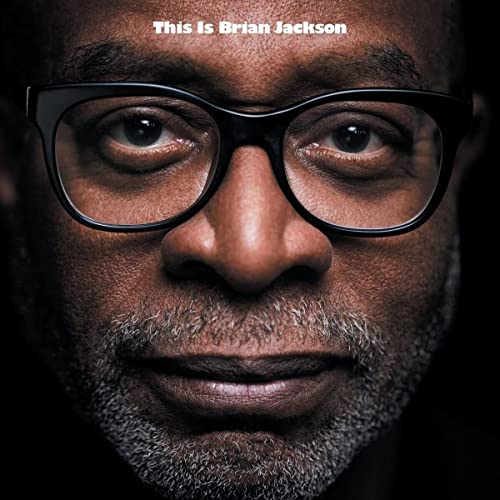 Close-up portrait of Brian Jackson wearing black-framed glasses.
