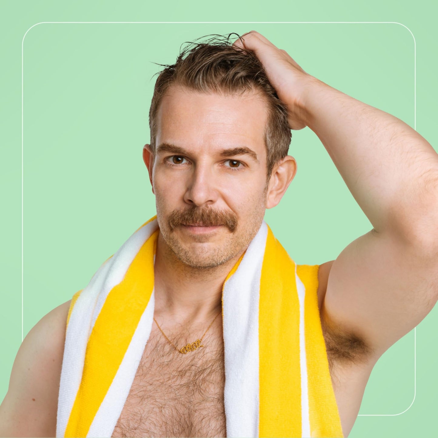 Portrait of a man with a mustache, wearing a yellow towel and gold chain.