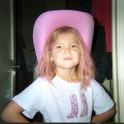Young person with pink hair wearing a large pink cowboy hat.