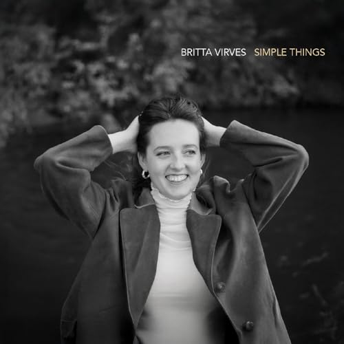 Black and white photo of Britta Virves smiling with hands behind her head.