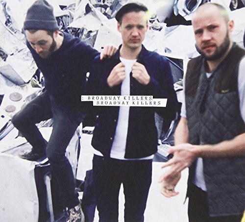 CD cover featuring three men standing amongst crushed vehicles.