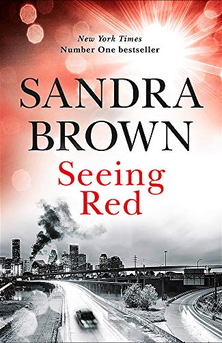 Book cover for “Seeing Red” by Sandra Brown, with a city skyline.