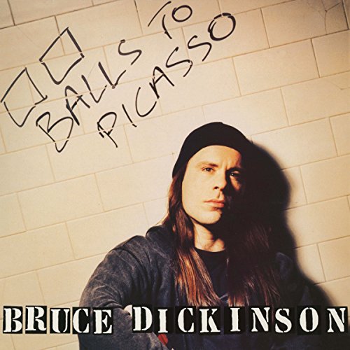 Album cover with man in black beanie and dark sweater against white tiled wall.