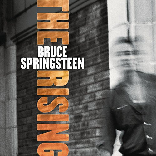 Bruce Springsteen’s “The Rising” CD cover with brick wall and portrait.