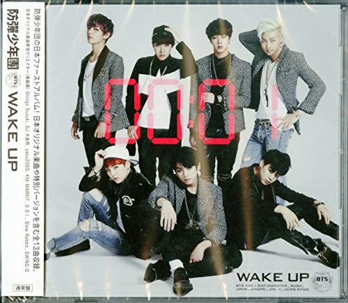 BTS album cover, “Wake Up”, featuring seven young men in dark clothing.