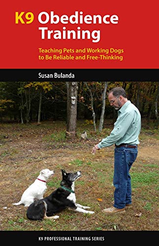 Book cover: man with two dogs in a wooded outdoor setting.