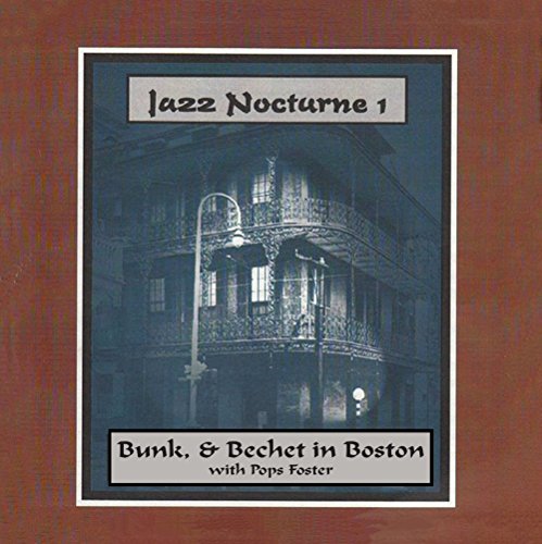 A CD cover with a blue-toned building image on a brown background.