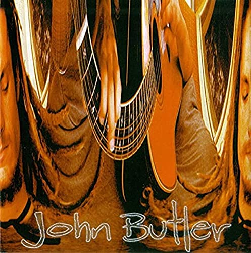 Close-up of a man playing guitar, album cover for John Butler.
