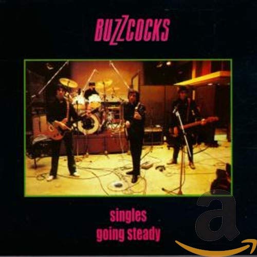 Buzzcocks album cover: band playing instruments onstage, black background.