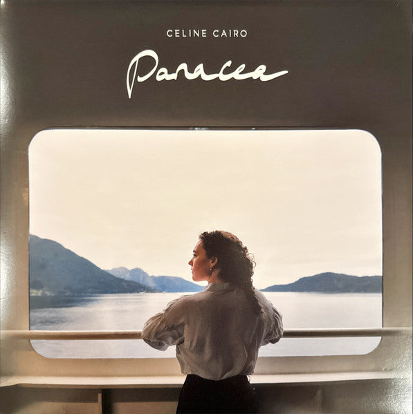 Vinyl record cover: woman looking at a mountainous seascape.