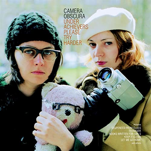 Two women with a vintage camera and teddy bear on album cover.