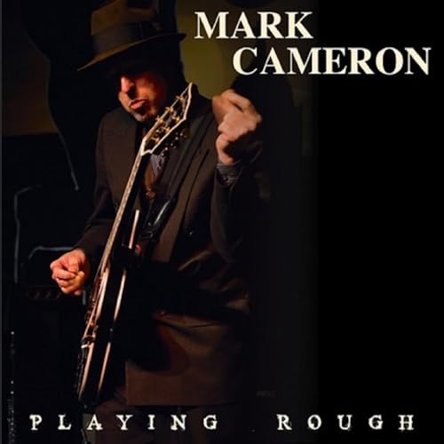 Mark Cameron in a hat playing a guitar, album cover "Playing Rough".