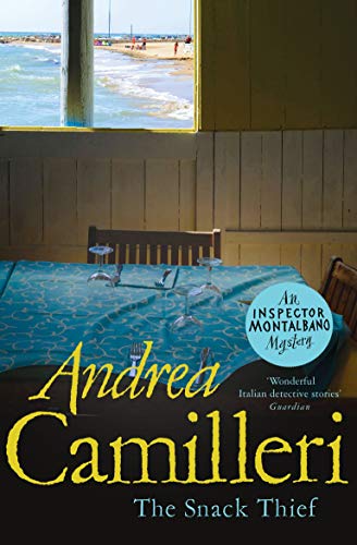 Book with dark or muted cover, featuring a Mediterranean setting or Italian landscape possibly.