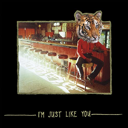 Album cover: man with a tiger head sitting at a bar.