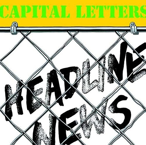 "Album cover with 'Capital Letters' in green and 'Headline News' behind a chain link fence."