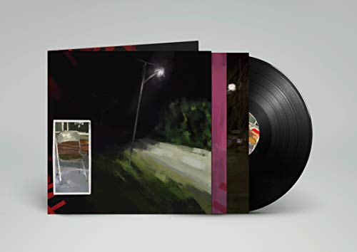 "Black vinyl record with cover art featuring a dark, painted street scene."