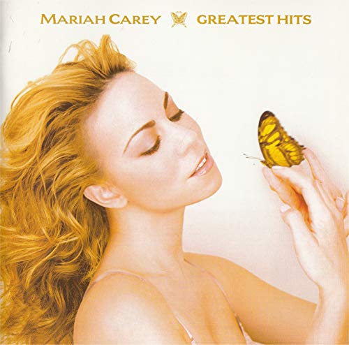 CD cover: Mariah Carey with a butterfly on her hand, golden tones.