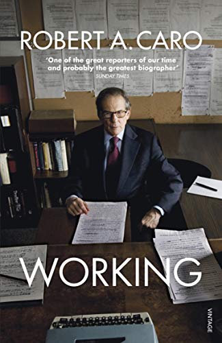 Book cover featuring author Robert Caro at a desk with papers.