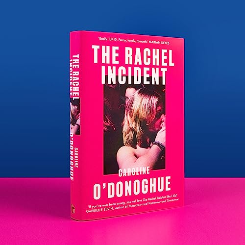 A bright pink book cover featuring a photo of a woman in a dark setting.