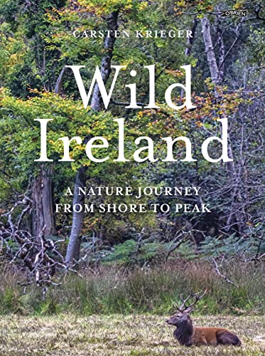 Book cover with stag in grassy field and forest backdrop.