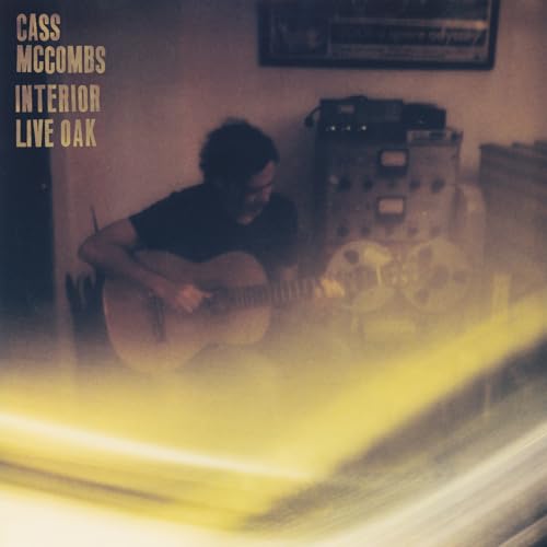 Cass McCombs album cover featuring a musician with an acoustic guitar.