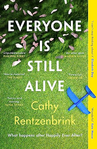 Book cover showing scattered petals on green grass with a blue toy airplane.