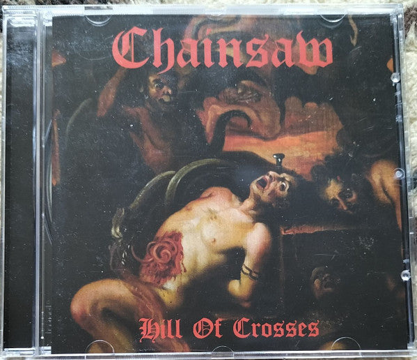 CD case for Chainsaw’s “Hill Of Crosses” with dark, dramatic artwork.