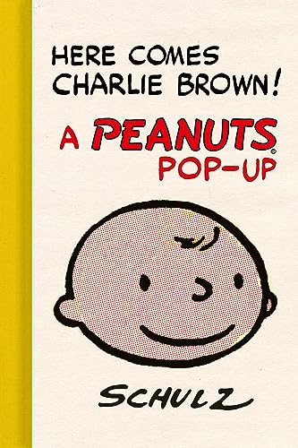 Cover of "Here Comes Charlie Brown!" pop-up book featuring Charlie Brown’s face.