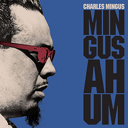 Charles Mingus album cover: portrait with red glasses and bold text.