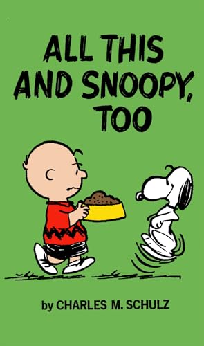 Charlie Brown holds dog food as Snoopy spins around beside him on green cover.