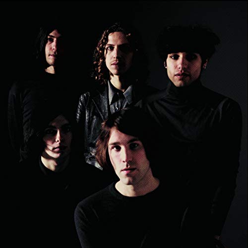 Five people with dark hair stare intensely at the viewer.
