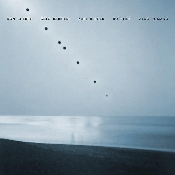Vinyl album cover: blue seascape with scattered dark dots and text.