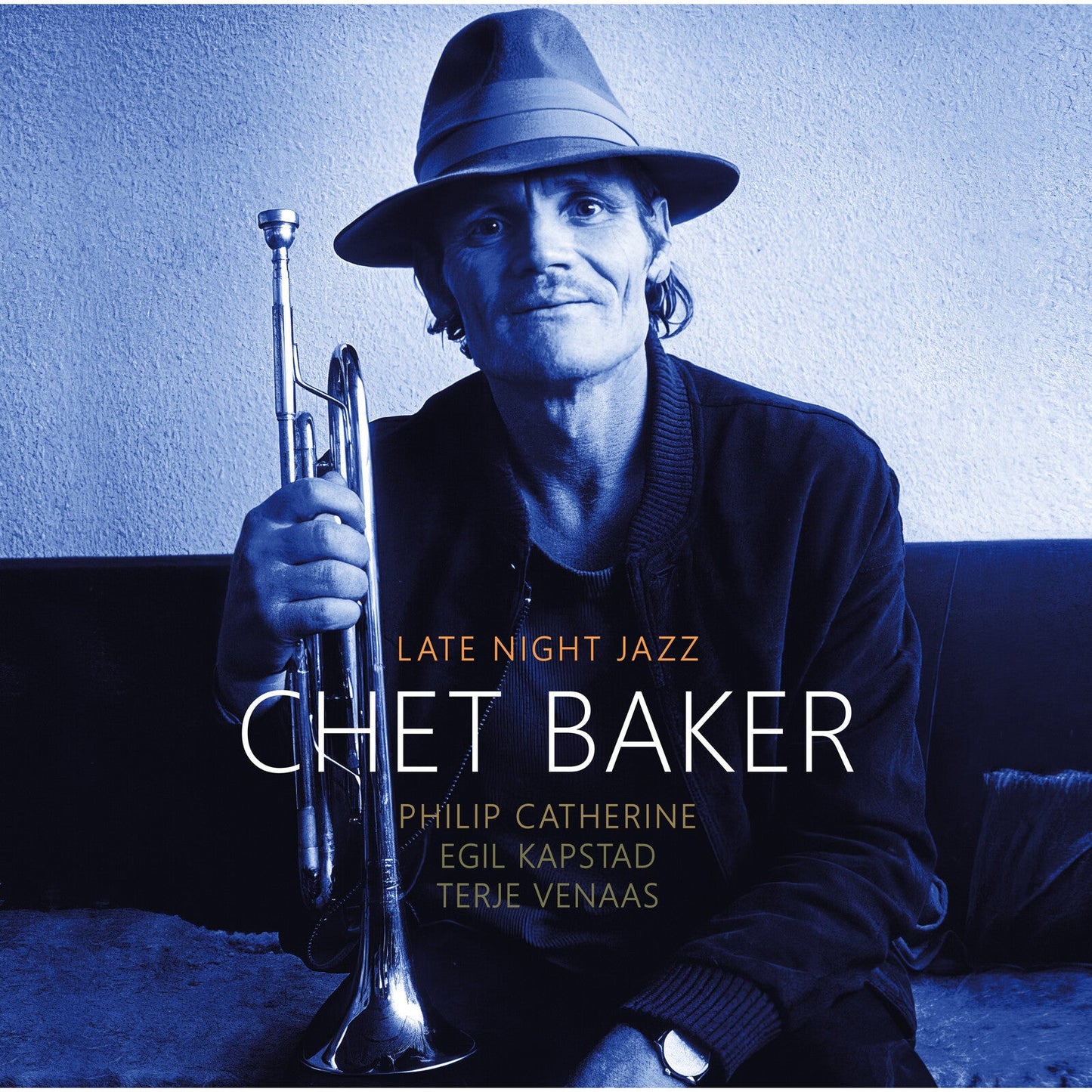 Chet Baker wearing a fedora and holding a trumpet in a blue-toned portrait.