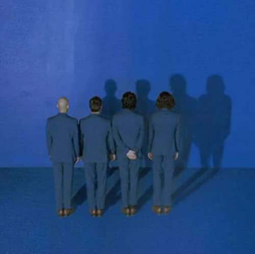 Four figures in suits stand against a blue wall with shadows.