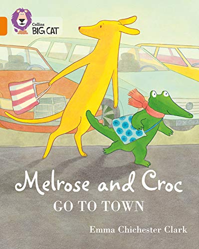 A yellow dog and green crocodile walk through a town street.