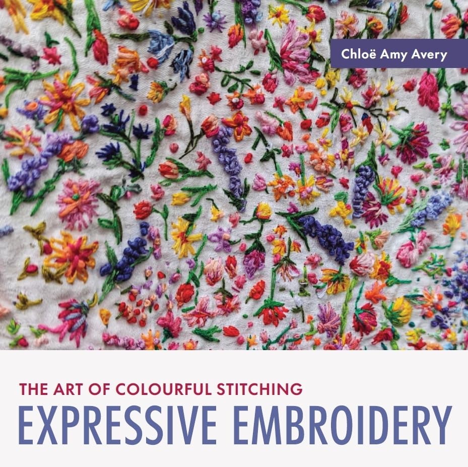 Close-up of colourful floral embroidery on white fabric with book title and author name.