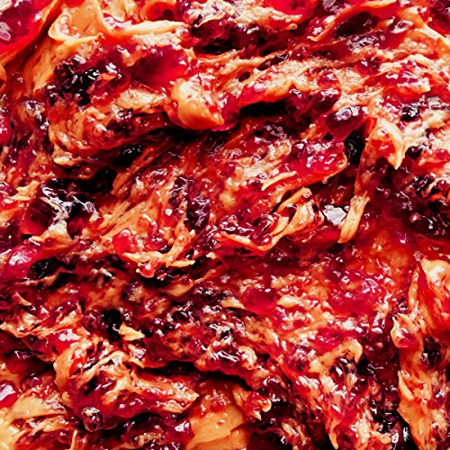 Close-up of a swirling, textured surface in shades of red and orange.