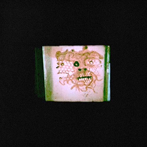 A CD case with a grotesque face illustration on a white background against a black backdrop.
