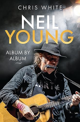 Book cover featuring Neil Young playing acoustic guitar and harmonica under a stage light.