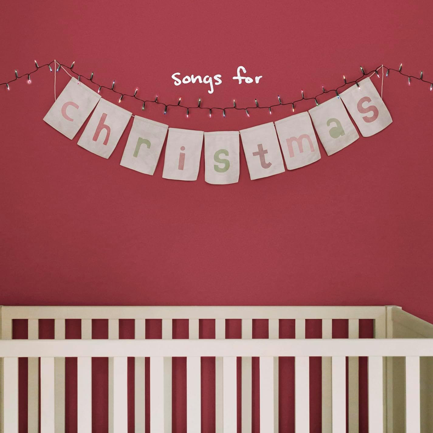 Album cover for “Songs for Christmas” with a banner and crib.