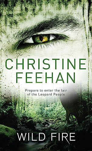 Book cover: close-up of a green eye over a forest landscape.