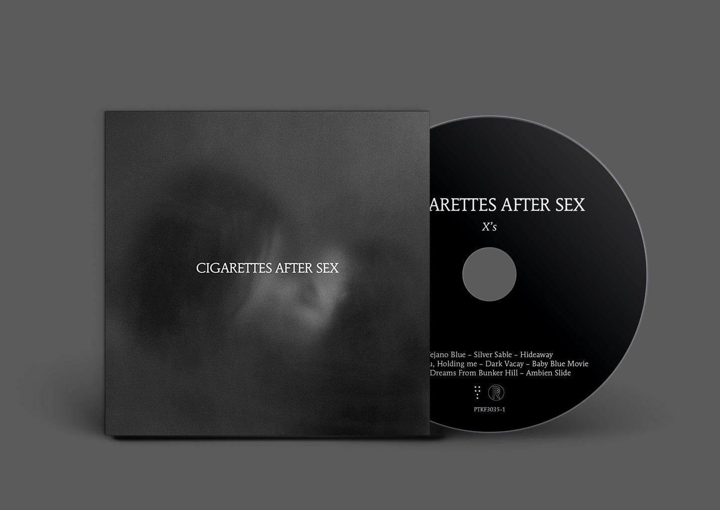 Black CD with white text: “Cigarettes After Sex - Xs” and tracklist.