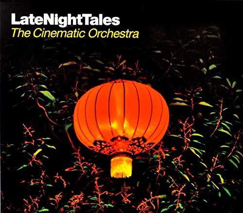 CD cover with a glowing orange lantern against dark foliage.