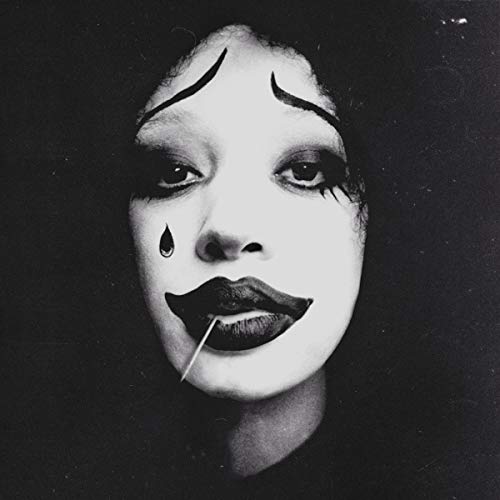 Black and white portrait of a person with dramatic clown makeup.