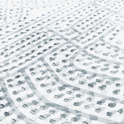 Black and white aerial view of a dense, repeating suburban landscape.