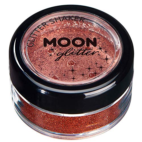 Small clear jar containing copper-bronze cosmetic glitter with a black lid and branded label.