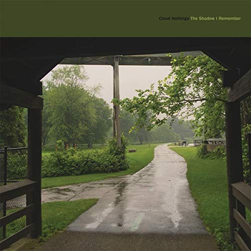 Album cover: a path through green trees framed by a dark structure.