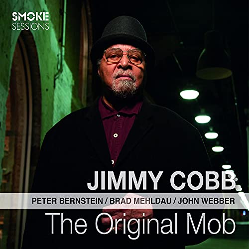 Jimmy Cobb album cover, portrait of a man in a hat, dark background.