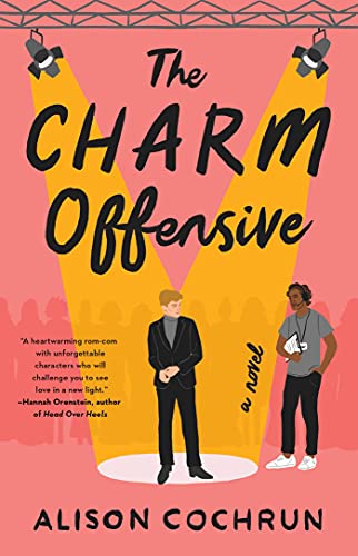 Book cover: “The Charm Offensive” with two men in a spotlight.