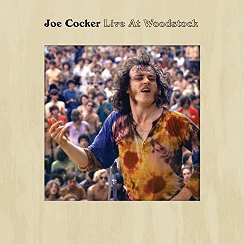 Joe Cocker performing at Woodstock, album cover with crowd in background.